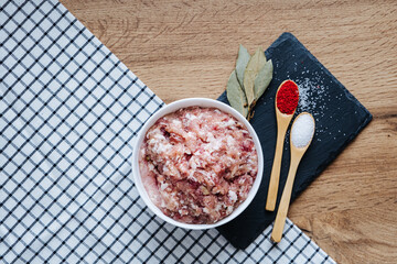 raw minced fresh meat on a wooden background spice pepper wooden spoon