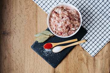 raw minced fresh meat on a wooden background spice pepper wooden spoon