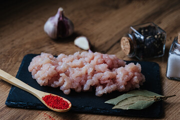 raw minced fresh meat on a wooden background spice pepper wooden spoon