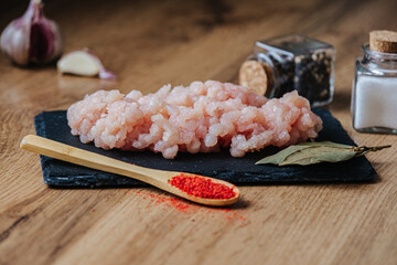 raw minced fresh meat on a wooden background spice pepper wooden spoon
