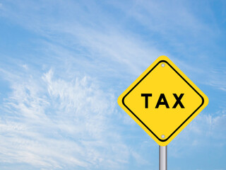 Yellow transportation sign with word tax on blue color sky background