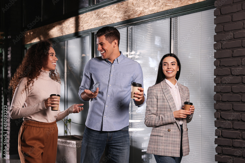 Poster Group of coworkers talking during coffee break in office