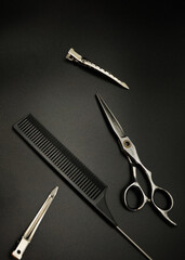 hairdressing tools lie on a black background close-up