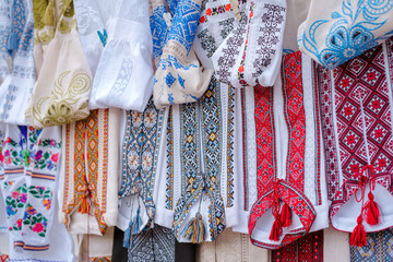 Different Ukrainian vintage clothes - traditional embroidered shirts, vyshyvanka. Traditional ukrainian dresses on souvenir market. Flea market Vernissage in Lviv, thrift shopping concept