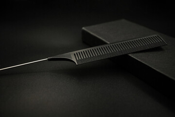 black plastic comb with metal tail