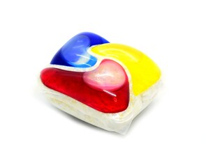 A closeup of one colorful washing detergent gel pod on white background.