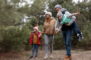 Happy family spending time together in forest