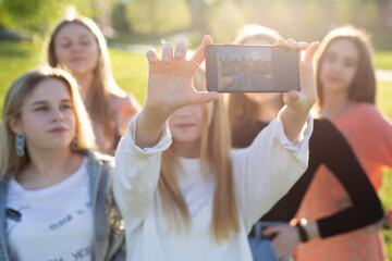 Group of happy smiling students or students taking pictures on their phone. Selfie