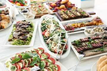 Variety of dishes on the banquet table in the restaurant