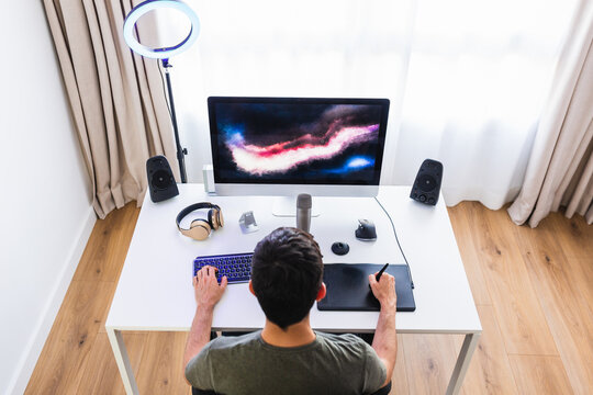 Designer working on computer with graphic tablet