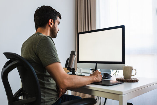 Designer working on computer with graphic tablet