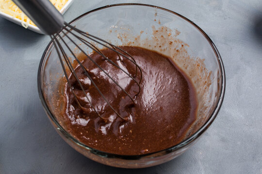 Bowl with chocolate waffle batter and whisk