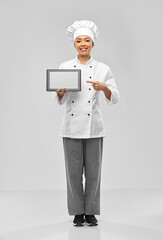 cooking, culinary and people concept - happy smiling female chef with tablet pc computer over grey background