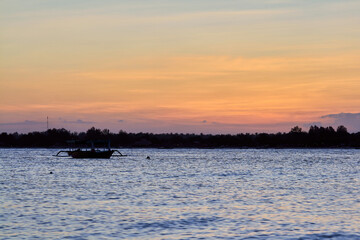 Magic Unreal Colorful Sunset with local boat in Indonesia
