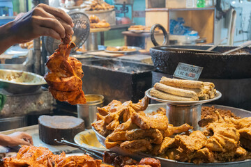 Spicy roasted tandoori butter chicken , prepared for sale at evening as street food in Old Delhi market. It is famous for spicy Indian non vegetarian street foods. It is famous tourist spot.