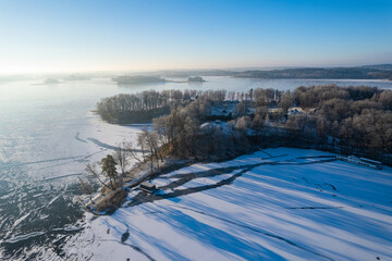 Aerial winter sunny day view of frozen Galve lake in Trakai, Lithuania