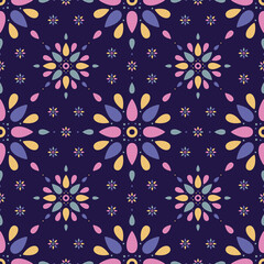Seamless pattern of brightly coloured simple mandala shapes on a dark blue background.
