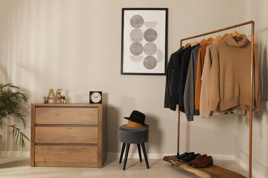 Modern dressing room interior with stylish clothes, shoes and decorative elements