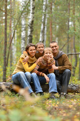 Portrait of family of four in park