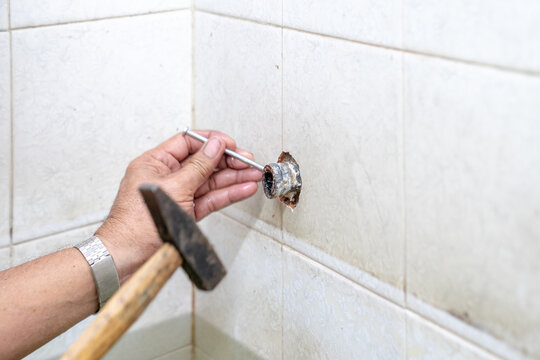 Asian Man Tries To Fix And Repair Pipe / Shower In The Old Restroom.