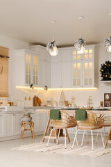 Cozy open plan kitchen decorated for Christmas. Interior design