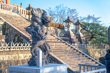 Two rock Asia dragons statue with yellow eye rolling the pole posture