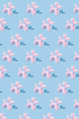 Pattern made with pink balloon dogs on pastel blue background. Minimal flat lay concept. Pink dogs layout. Balloon pets minimal composition. Birthday celebration mood.