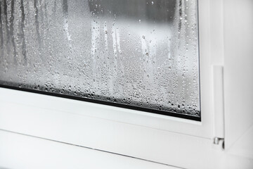 a plastic window with condensation of water on the glass. Double glazed PVC window. Concept:...