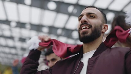 Arabian guy supporting national team during soccer match