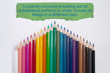 Creativity involves breaking out of
established patterns in order to look at things in a different way. Motivational quote on white background with color pencil  