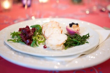Pretty and chic lobster plate with salicorne, half pink egg and salad.