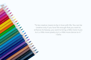 Text sign showing Osho quote about being creative on Set of colorful paper clips with white copy space background.