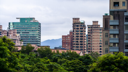 Fototapeta premium Aerial view of corporate landmark skyline and forest park in modern city Taiwan