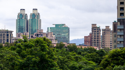 Fototapeta premium Aerial view of corporate landmark skyline and forest park in modern city Taiwan