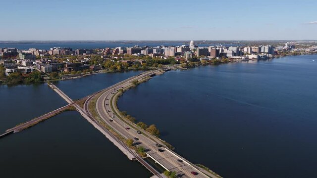 In Olin Park Flying Over John Nolen Drive towards Downtown Madison, Wisconsin Surrounded by Fall Colors (Drone - Tracking Backwards)