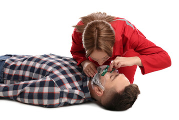 Paramedic in uniform performing first aid on unconscious man against white background - obrazy, fototapety, plakaty
