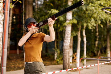 Side view gun point of rifle machine gun. Firearm shooting and tactical weapons training. Outdoor...