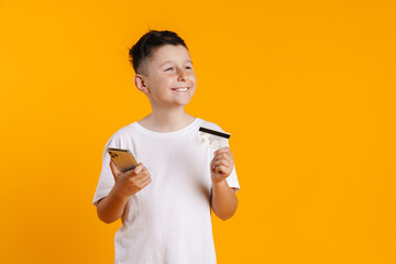 Brunette white boy posing with credit card and cellphone