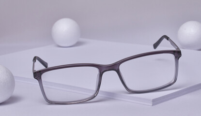 Pair of stylish glasses resting on some white paper.