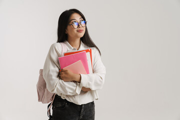 Young asian woman in eyeglasses posing with exercise books