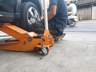Employees repairing tires cars in local car service