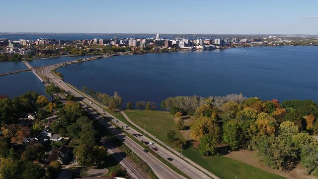 Flying Over John Nolen Drive towards Downtown Madison, Wisconsin Surrounded by Fall Colors (Drone - Tracking Left of Street)