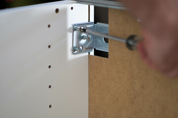 Asembilg ready made furniture with a hand screwdriver.
