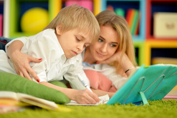 Mother with her son doing homework at home