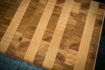 Handmade cutting board on a dark background. Close wood texture