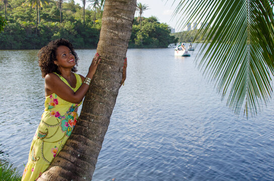 Portrait Of A Beautiful Black Woman Leaning Against A Tree