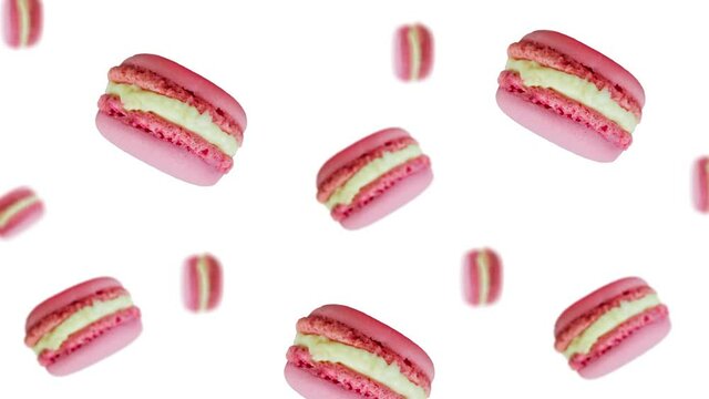 A stream of many different diameters French macaroon cookies with raspberry and strawberry on a white color background. The Concept of St. Valentine's, weddings, birthday days and other holiday 