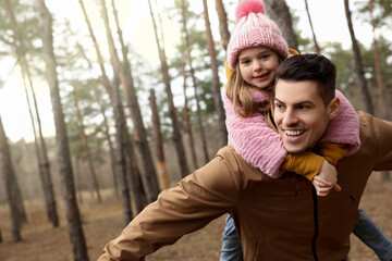 Fototapeta premium Man and his daughter spending time together in forest