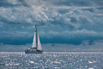 sailing boat on the sea with cloudy sky
