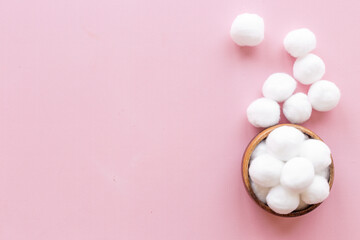 Delicate soft cotton balls in bowl. Cosmetic makeup remover supplies